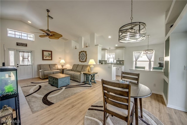 dining room with lofted ceiling, visible vents, light wood finished floors, and recessed lighting