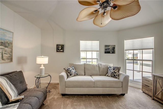 living room with light carpet, ceiling fan, and baseboards