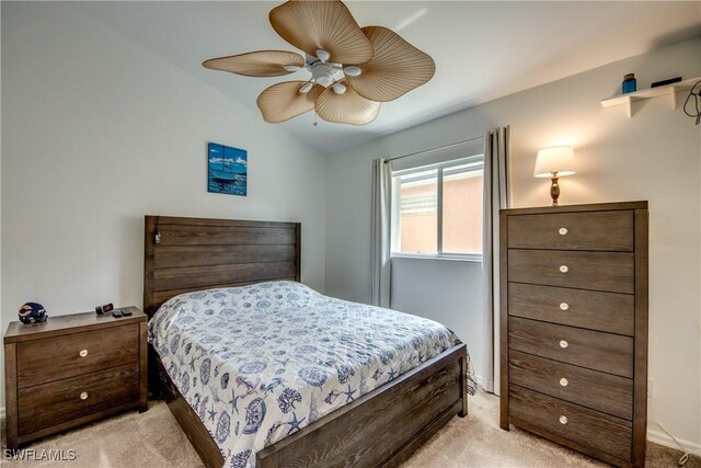 bedroom with light carpet, ceiling fan, and vaulted ceiling