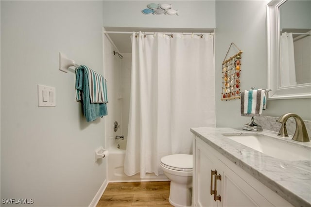 bathroom featuring toilet, shower / bath combination with curtain, wood finished floors, and vanity