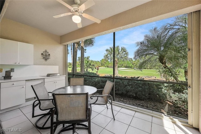 sunroom featuring ceiling fan