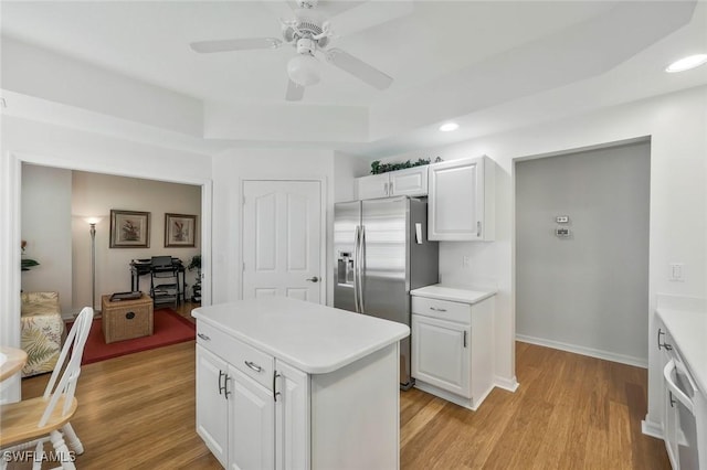 kitchen with light countertops, light wood-style floors, and stainless steel refrigerator with ice dispenser