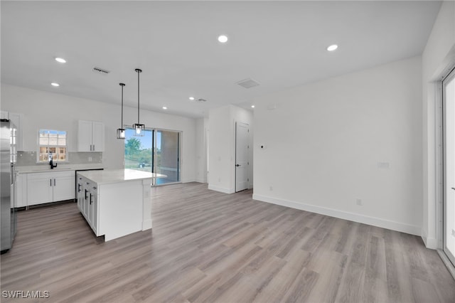 3109 11th St W, Lehigh Acres, FL 33971 - kitchen featuring light countertops, recessed lighting, open floor plan, a kitchen island, and visible vents