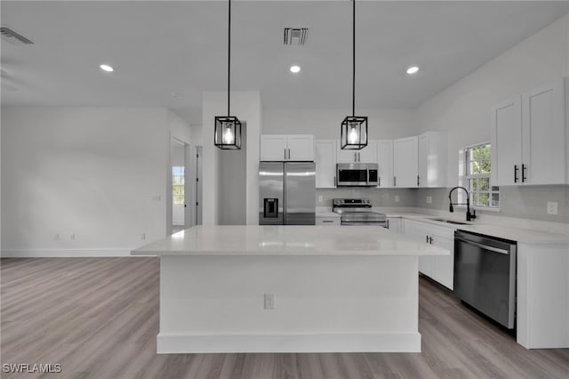 3109 11th St W, Lehigh Acres, FL 33971 - kitchen with visible vents, a sink, light wood-style flooring, and stainless steel appliances