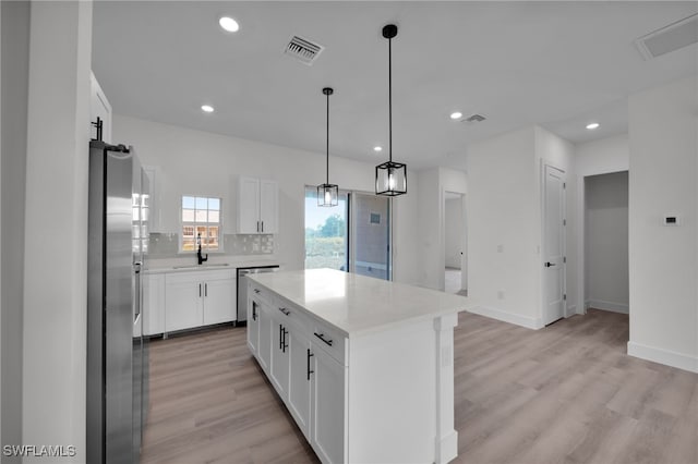 3109 11th St W, Lehigh Acres, FL 33971 - kitchen featuring light countertops, backsplash, appliances with stainless steel finishes, and light wood-style floors