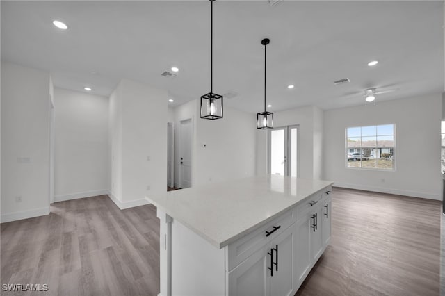 3109 11th St W, Lehigh Acres, FL 33971 - kitchen featuring open floor plan, visible vents, baseboards, and light wood-style floors