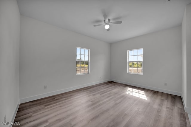 3109 11th St W, Lehigh Acres, FL 33971 - spare room featuring a ceiling fan, baseboards, and wood finished floors