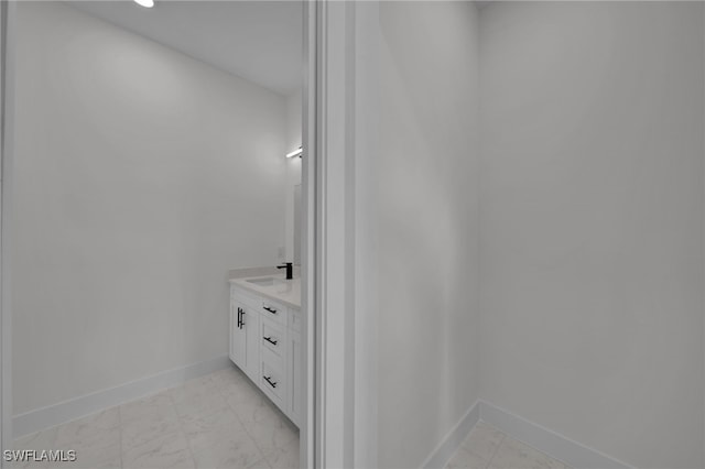 3109 11th St W, Lehigh Acres, FL 33971 - bathroom featuring baseboards, vanity, and marble finish floor