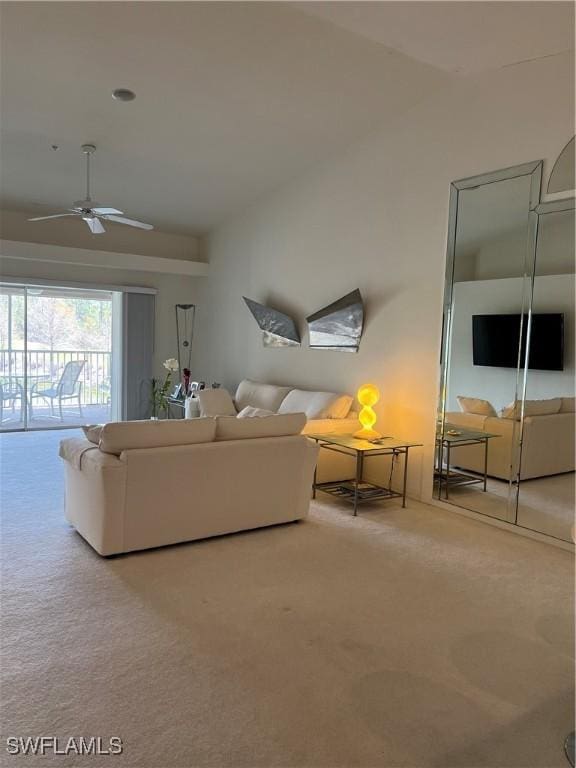 unfurnished living room with lofted ceiling, carpet, and ceiling fan