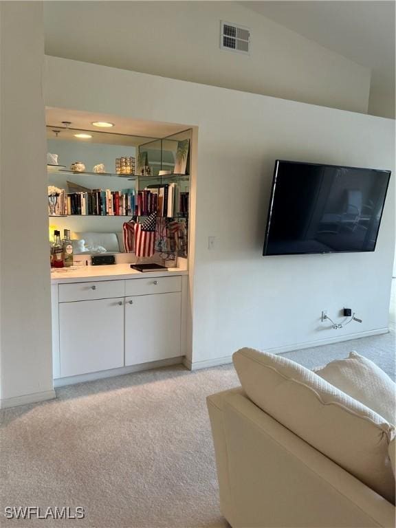 living room with visible vents and light colored carpet