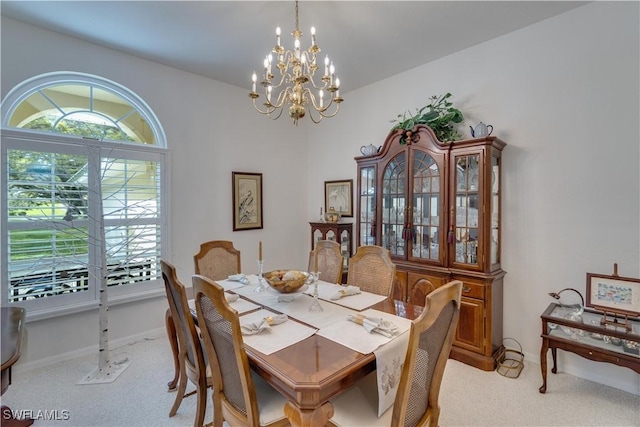 1132 Riverbend Dr, Labelle, FL 33935 - dining area with light carpet, an inviting chandelier, and baseboards