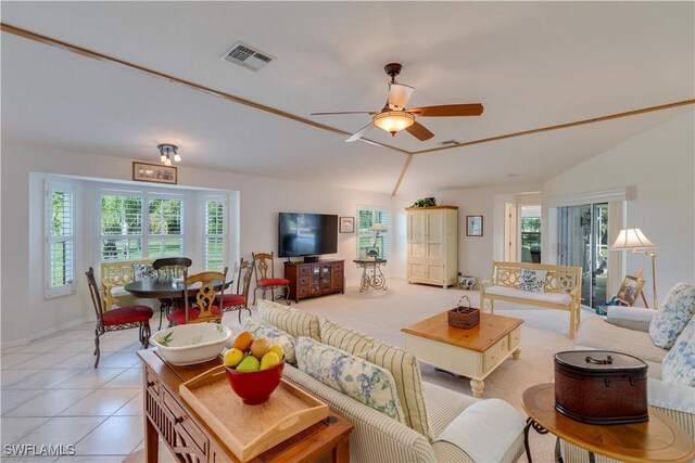 1132 Riverbend Dr, Labelle, FL 33935 - living room with lofted ceiling, light tile patterned floors, ceiling fan, and visible vents