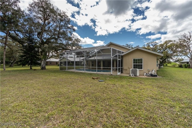 1132 Riverbend Dr, Labelle, FL 33935 - rear view of property with a yard, stucco siding, a lanai, and an outdoor pool