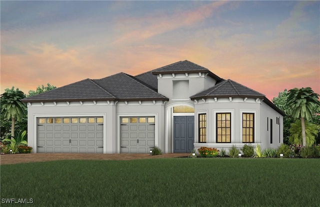 view of front of home featuring a lawn and an attached garage