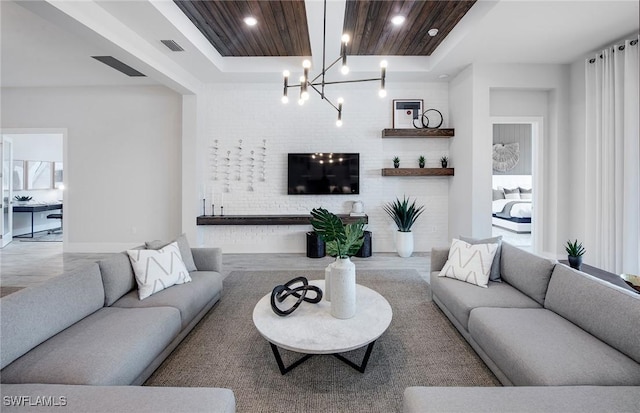 living room featuring a tray ceiling, recessed lighting, visible vents, an inviting chandelier, and wood ceiling