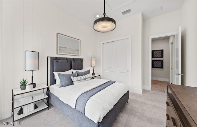 bedroom featuring a closet, baseboards, visible vents, and carpet flooring