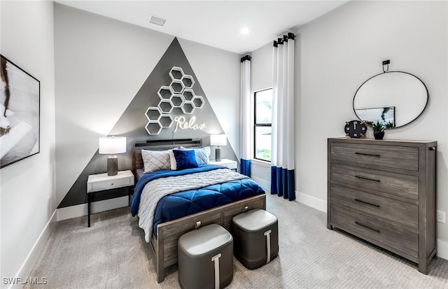 bedroom with baseboards, visible vents, and light colored carpet