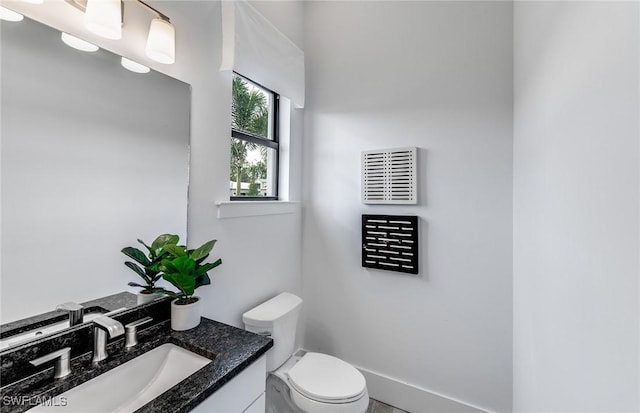 bathroom with toilet, visible vents, and vanity