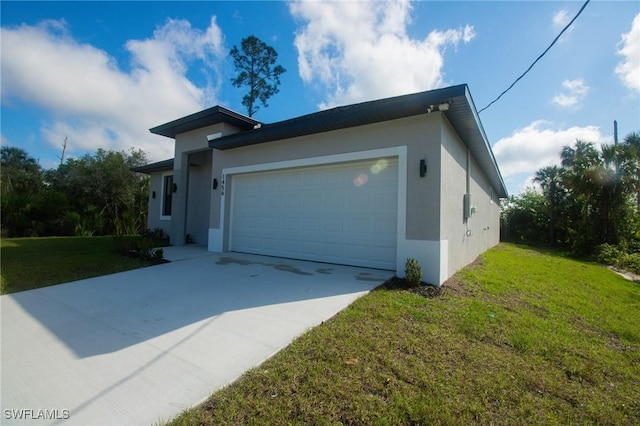 view of side of property featuring concrete driveway, a yard, an attached garage, and stucco siding