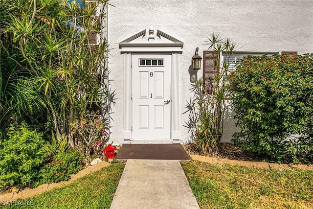 property entrance featuring stucco siding