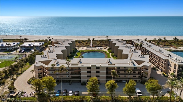 drone / aerial view featuring a view of the beach and a water view