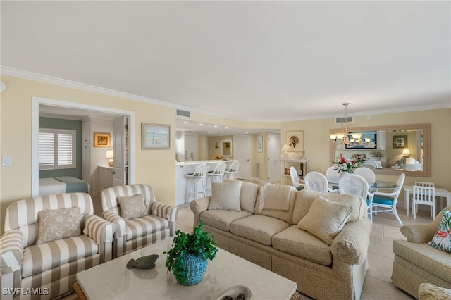 living area with visible vents, an inviting chandelier, ornamental molding, and light tile patterned flooring