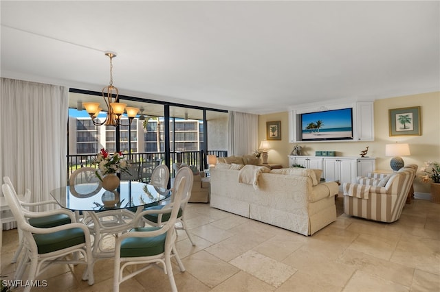 living area with expansive windows, a notable chandelier, and stone tile floors