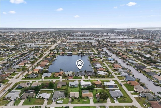 birds eye view of property with a water view and a residential view