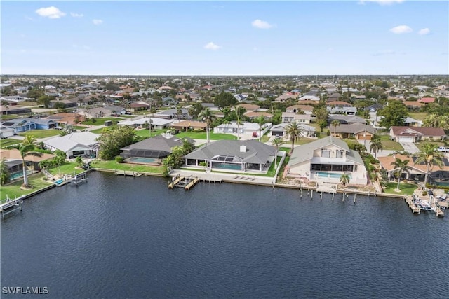 birds eye view of property featuring a water view and a residential view