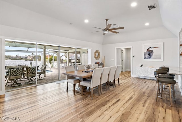 dining space with vaulted ceiling, recessed lighting, visible vents, and light wood-style floors