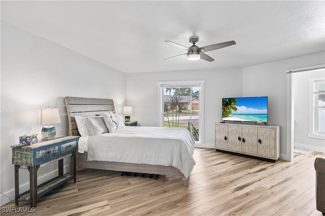 bedroom featuring access to outside, baseboards, ceiling fan, and wood finished floors