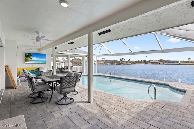 outdoor pool featuring a ceiling fan, glass enclosure, a water view, a patio area, and outdoor dining space