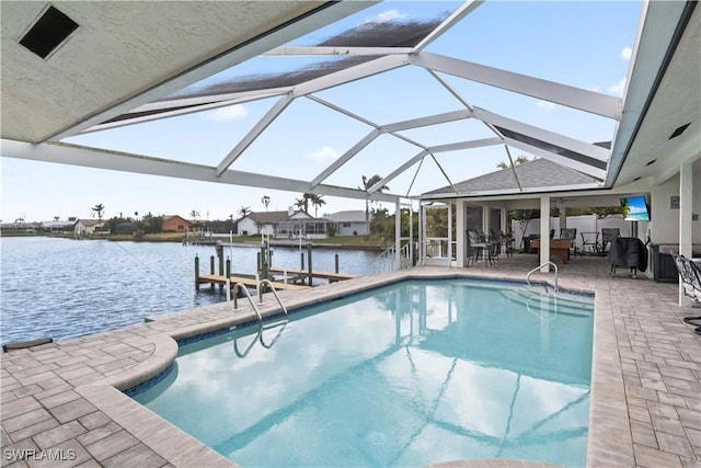 outdoor pool featuring a dock, a lanai, and a patio area