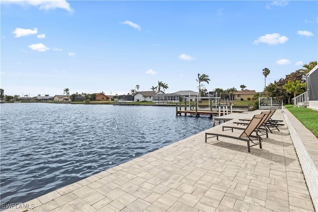 dock area with a residential view, a water view, and boat lift