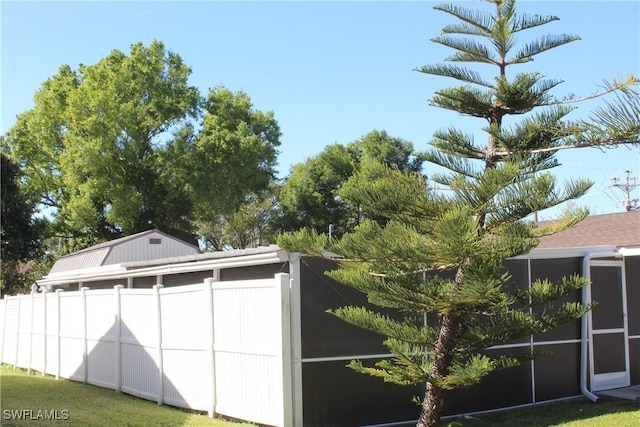 view of outbuilding featuring fence