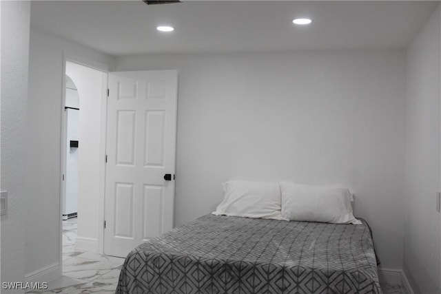 bedroom featuring recessed lighting, marble finish floor, and baseboards