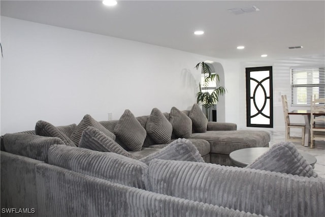 living area featuring recessed lighting and visible vents