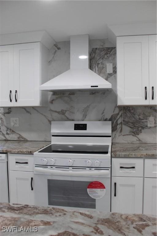 kitchen with white appliances, light stone counters, white cabinets, wall chimney exhaust hood, and backsplash