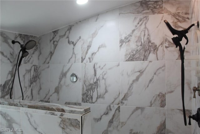 full bathroom with a marble finish shower