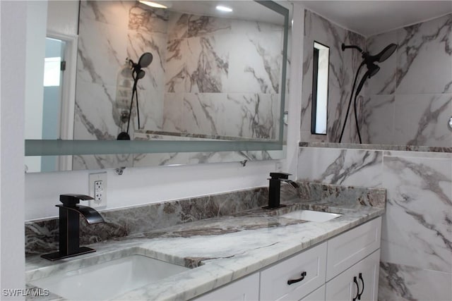 full bathroom featuring double vanity, tile walls, and a sink