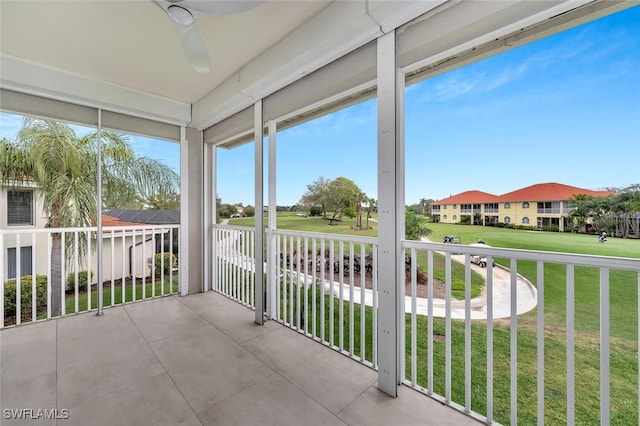 unfurnished sunroom with a ceiling fan