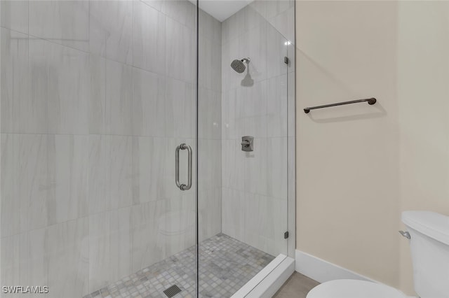 bathroom with toilet and a shower stall