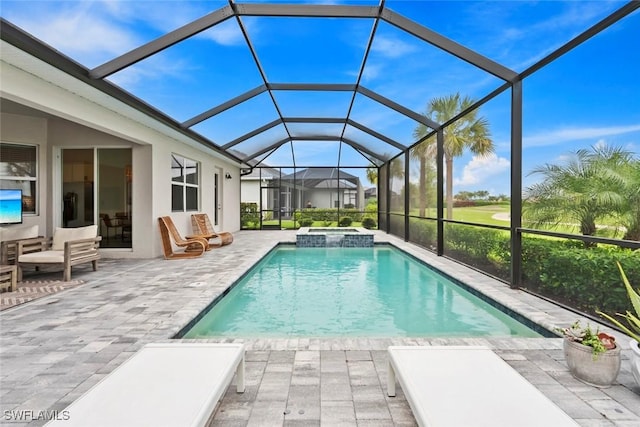 view of swimming pool featuring a lanai, a pool with connected hot tub, and a patio