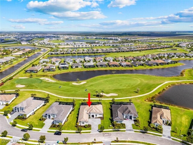 bird's eye view with a water view, view of golf course, and a residential view