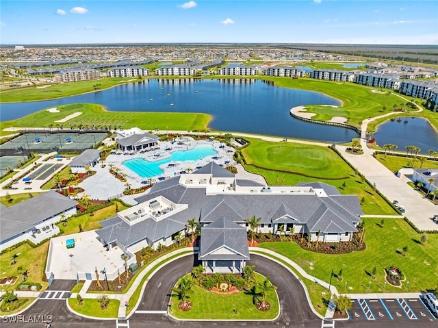 drone / aerial view with a water view and view of golf course