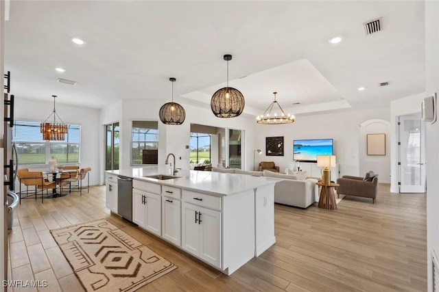 kitchen featuring visible vents, an inviting chandelier, light wood-style floors, a sink, and dishwasher