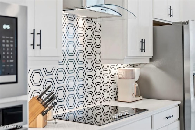 interior space featuring light countertops, decorative backsplash, and white cabinets