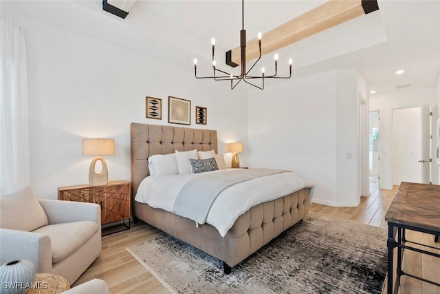 bedroom with baseboards, wood finished floors, and recessed lighting