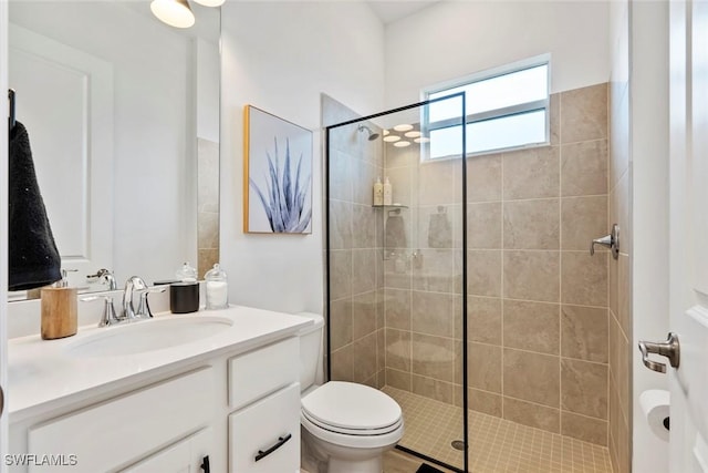 full bathroom featuring toilet, tiled shower, and vanity