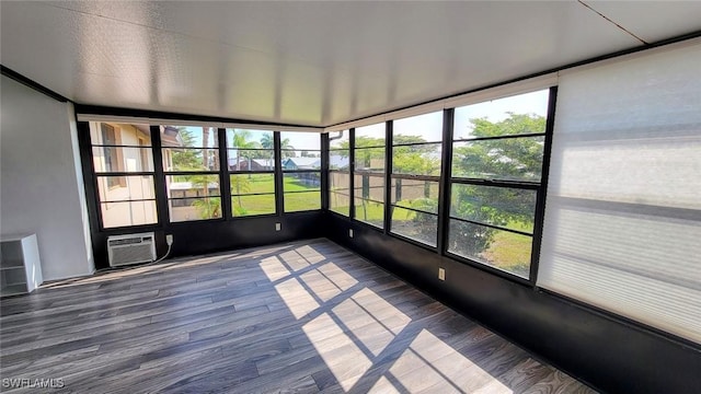 unfurnished sunroom featuring a wall unit AC